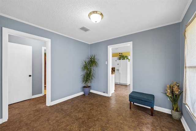 3801 Fort Ave, Waco, TX 76710 - empty room featuring crown molding, tile patterned floors, baseboards, and a textured ceiling