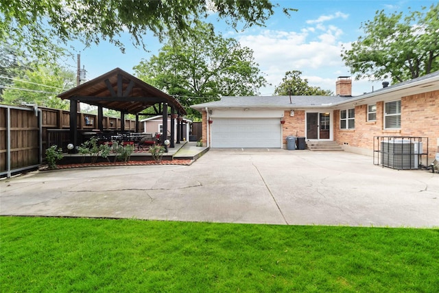 5818 Meadowick Ln, Dallas, TX 75227 - view of yard featuring driveway, a gazebo, a garage, entry steps, and a storage shed