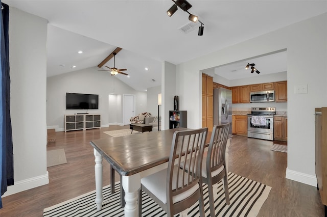 2434 Antler Trl, Lewisville, TX 75067 - dining space featuring dark wood-style flooring, vaulted ceiling, a ceiling fan, and baseboards