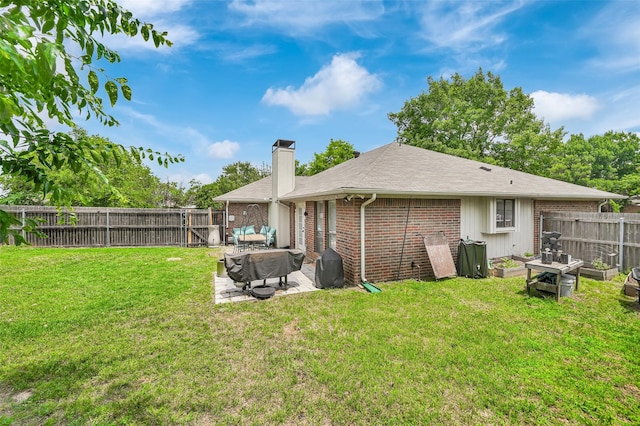 2434 Antler Trl, Lewisville, TX 75067 - rear view of house featuring brick siding, a patio, a chimney, and roof with shingles