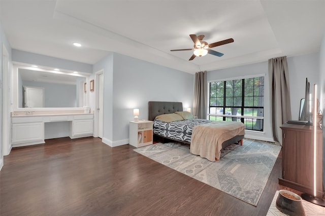 2434 Antler Trl, Lewisville, TX 75067 - bedroom featuring dark wood-type flooring, baseboards, a raised ceiling, a ceiling fan, and recessed lighting