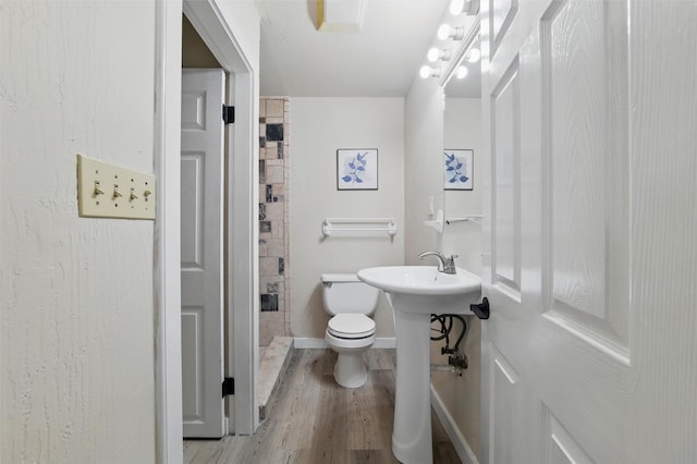 304 E Lee Ave, Weatherford, TX 76086 - bathroom with wood finished floors, toilet, and baseboards