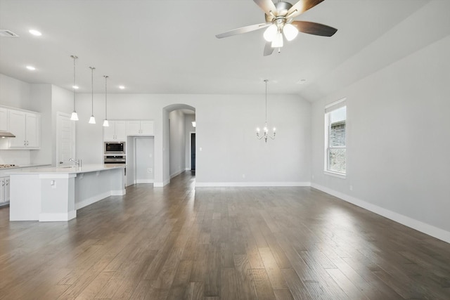 2805 Upland Trail Ln, Aubrey, TX 76227 - unfurnished living room with arched walkways, a ceiling fan, recessed lighting, a chandelier, and baseboards
