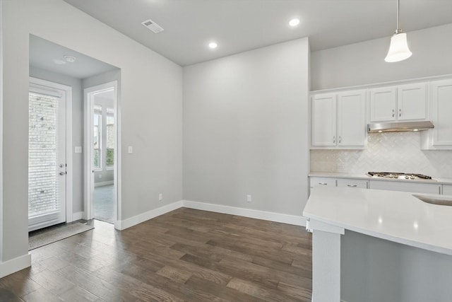 2805 Upland Trail Ln, Aubrey, TX 76227 - kitchen featuring light countertops, white cabinetry, dark wood-type flooring, stainless steel gas cooktop, and decorative backsplash