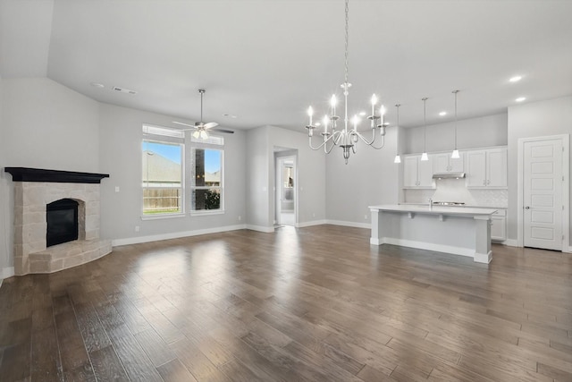 2805 Upland Trail Ln, Aubrey, TX 76227 - unfurnished living room with baseboards, recessed lighting, a chandelier, a fireplace, and dark wood-style flooring