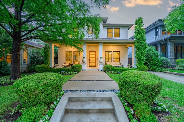 view of front of property with brick siding and a porch