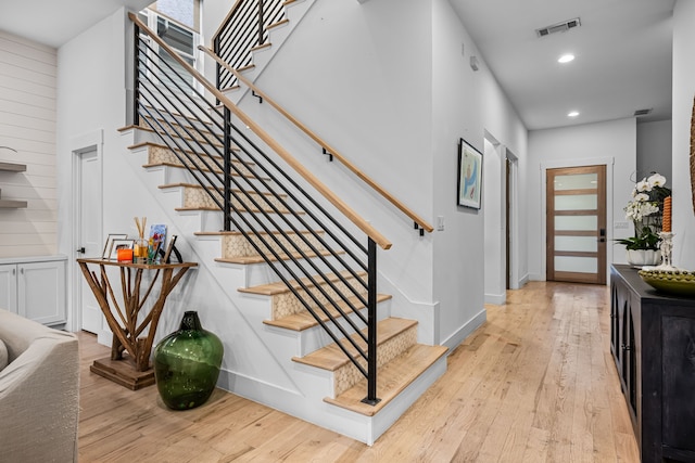 stairway featuring hardwood / wood-style floors, recessed lighting, and baseboards