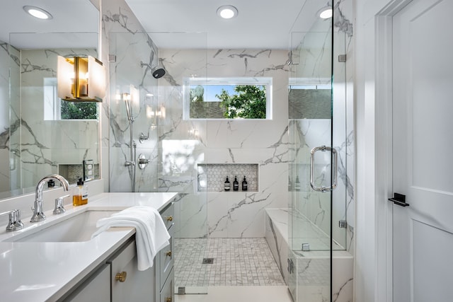 bathroom with plenty of natural light, vanity, a marble finish shower, and recessed lighting