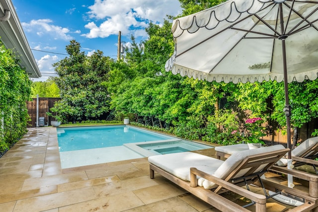 view of pool featuring an in-ground hot tub, a patio area, and a fenced backyard