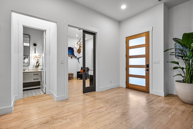 entrance foyer featuring light wood-type flooring, baseboards, and recessed lighting