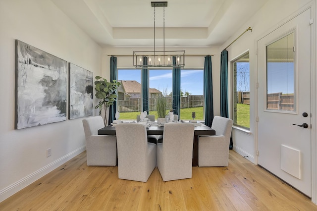 1208 Thornhill Ct, Roanoke, TX 76262 - dining space with a tray ceiling, baseboards, plenty of natural light, and light wood-type flooring