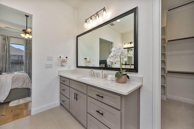 1208 Thornhill Ct, Roanoke, TX 76262 - ensuite bathroom featuring baseboards, ceiling fan, vanity, tile patterned flooring, and a spacious closet