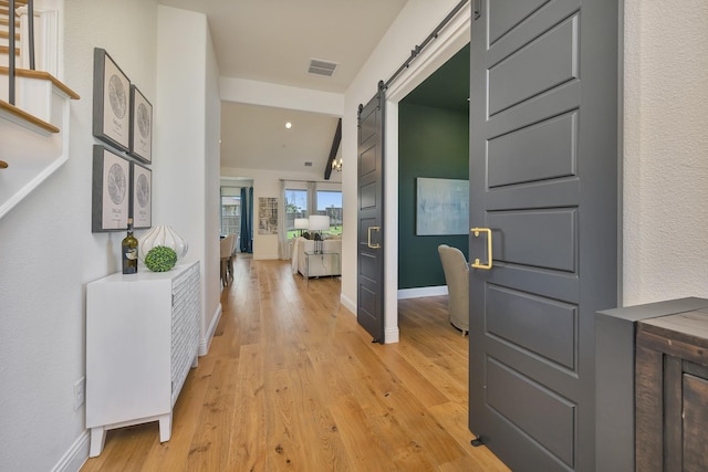 1208 Thornhill Ct, Roanoke, TX 76262 - corridor with a barn door, light wood-style flooring, and baseboards