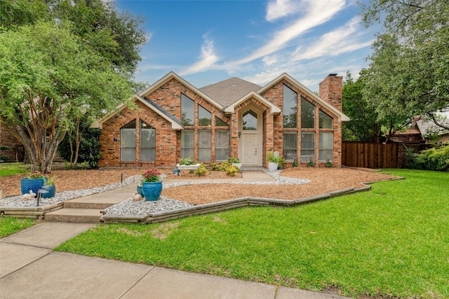 2203 Glen Helen Cir, Carrollton, TX 75007 - view of front facade featuring brick siding, a chimney, and roof with shingles