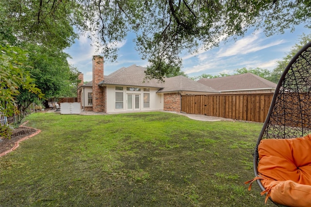 2203 Glen Helen Cir, Carrollton, TX 75007 - back of property with a patio area, a chimney, brick siding, french doors, and a shingled roof