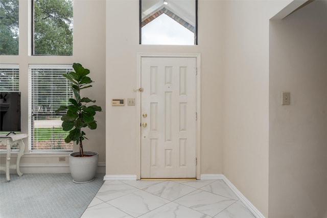2203 Glen Helen Cir, Carrollton, TX 75007 - entrance foyer with a towering ceiling, marble finish floors, and baseboards