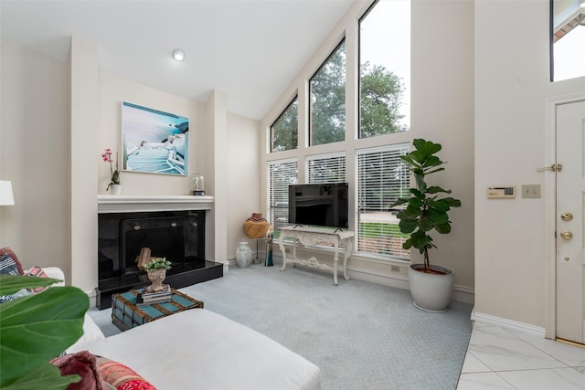 2203 Glen Helen Cir, Carrollton, TX 75007 - living room with a fireplace with raised hearth, baseboards, carpet flooring, and high vaulted ceiling