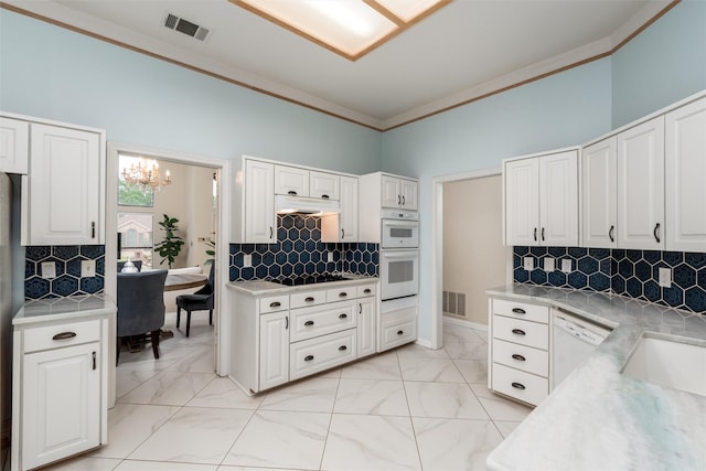 2203 Glen Helen Cir, Carrollton, TX 75007 - kitchen featuring under cabinet range hood, white appliances, light countertops, crown molding, and decorative backsplash
