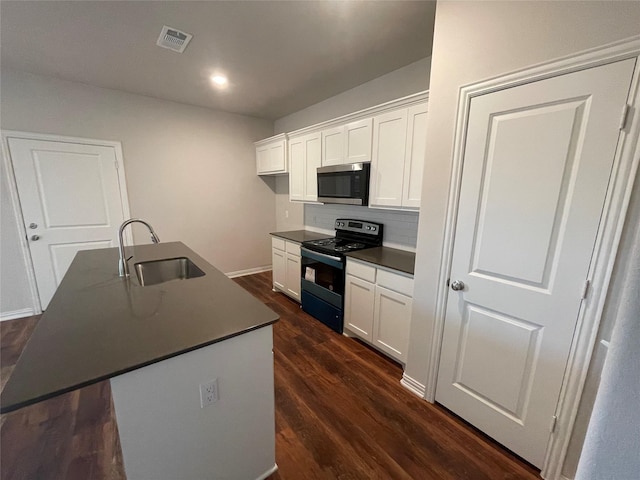 2829-2833 Peony Dr, Sherman, TX 75092 - kitchen with black electric range oven, stainless steel microwave, a sink, dark countertops, and white cabinets
