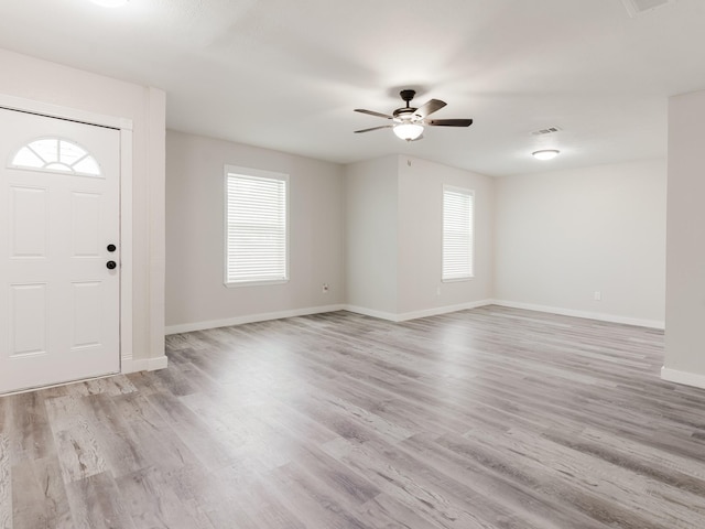 501 Edgewood Ave, Corsicana, TX 75110 - foyer entrance with plenty of natural light, a ceiling fan, baseboards, and light wood-type flooring