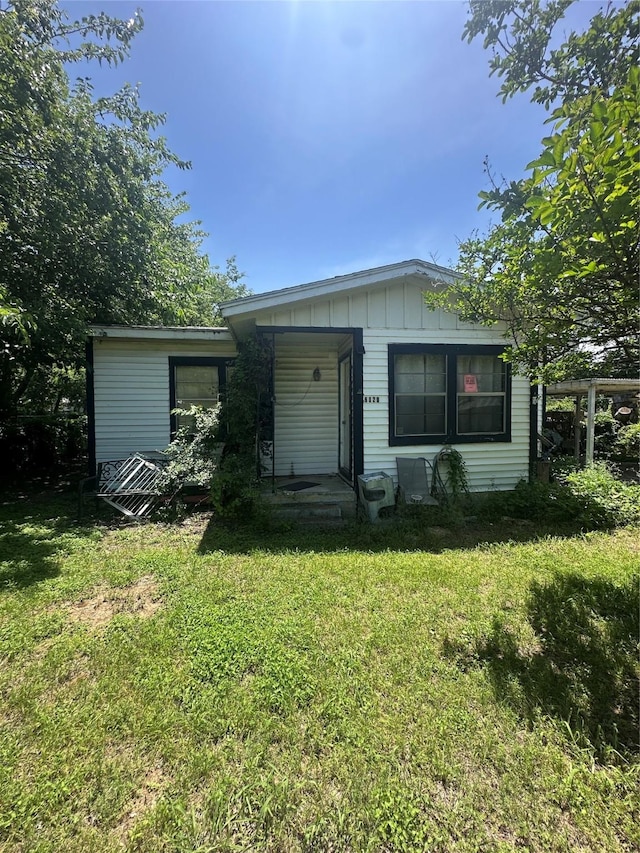 6029 Graham St, Lake Worth, TX 76135 - view of front of home with board and batten siding and a front lawn