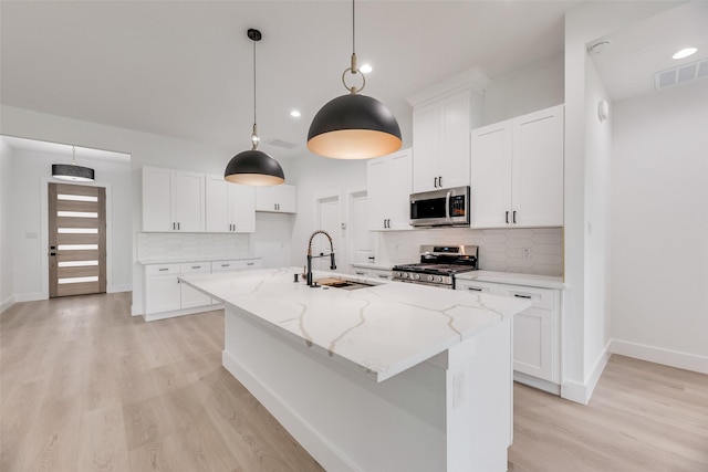 1008 Saint Matthew Cir, Royse City, TX 75189 - kitchen with appliances with stainless steel finishes, a sink, light wood-style floors, backsplash, and light stone countertops