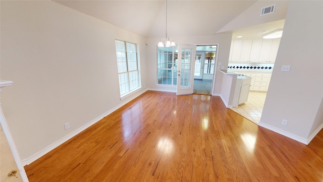 1913 Monte Cristo Way, Sherman, TX 75092 - unfurnished dining area featuring light wood-type flooring, vaulted ceiling, a chandelier, and baseboards