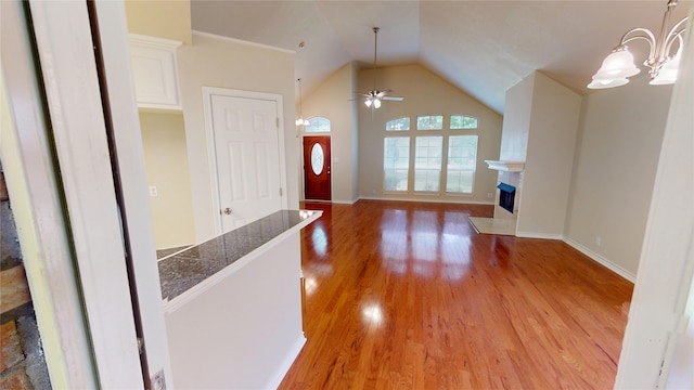 1913 Monte Cristo Way, Sherman, TX 75092 - entryway with light wood-style flooring, a fireplace, ceiling fan, lofted ceiling, and baseboards