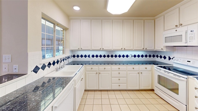 1913 Monte Cristo Way, Sherman, TX 75092 - kitchen with white appliances, a sink, dark countertops, white cabinets, and light tile patterned floors