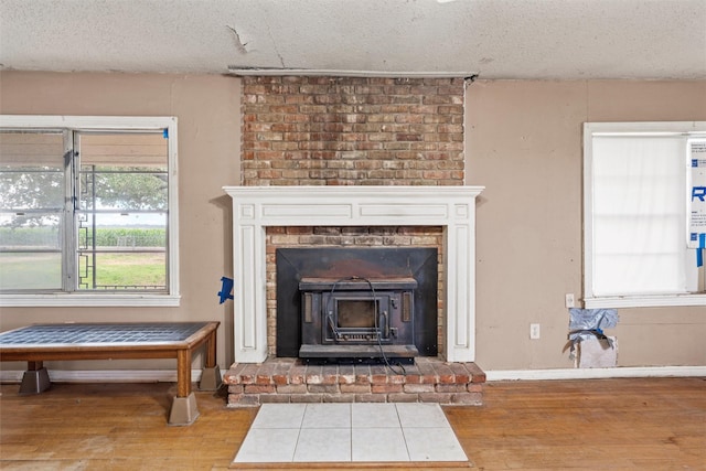 1677 Hobbs Ln, Waco, TX 76706 - detailed view of wood finished floors, a textured ceiling, and a wood stove