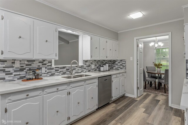 817 S Spruce St, Vivian, LA 71082 - kitchen featuring stainless steel dishwasher, a sink, white cabinetry, tasteful backsplash, and wood finished floors