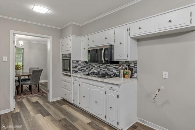 817 S Spruce St, Vivian, LA 71082 - kitchen featuring appliances with stainless steel finishes, decorative backsplash, white cabinetry, ornamental molding, and baseboards