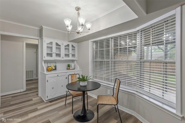 817 S Spruce St, Vivian, LA 71082 - dining room with a chandelier, light wood-style floors, baseboards, and crown molding