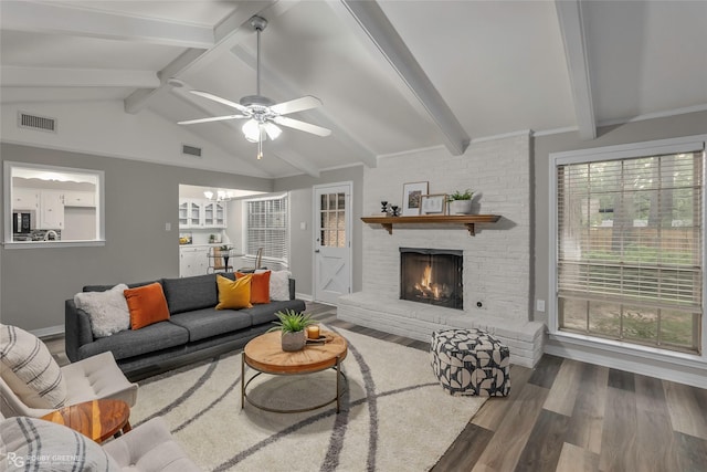 817 S Spruce St, Vivian, LA 71082 - living area with wood finished floors, a ceiling fan, a fireplace, and baseboards