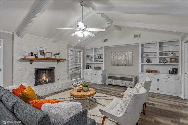 817 S Spruce St, Vivian, LA 71082 - living room with dark wood finished floors, ceiling fan, a brick fireplace, and built in shelves