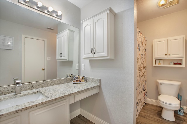 1034 Palomino Dr, Little Elm, TX 75068 - full bath featuring wood finished floors, toilet, baseboards, vanity, and a shower with shower curtain