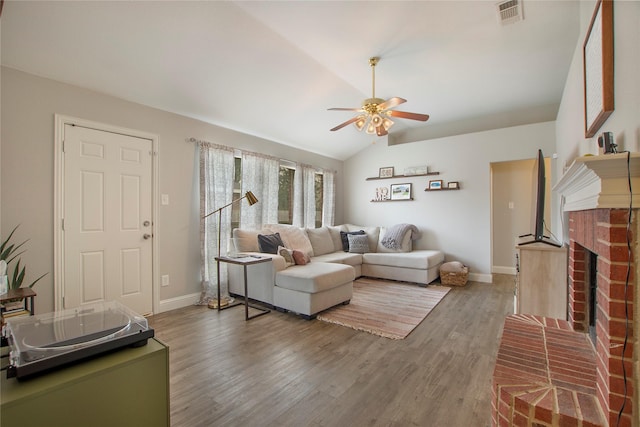 1034 Palomino Dr, Little Elm, TX 75068 - living area with a ceiling fan, vaulted ceiling, baseboards, wood finished floors, and a fireplace