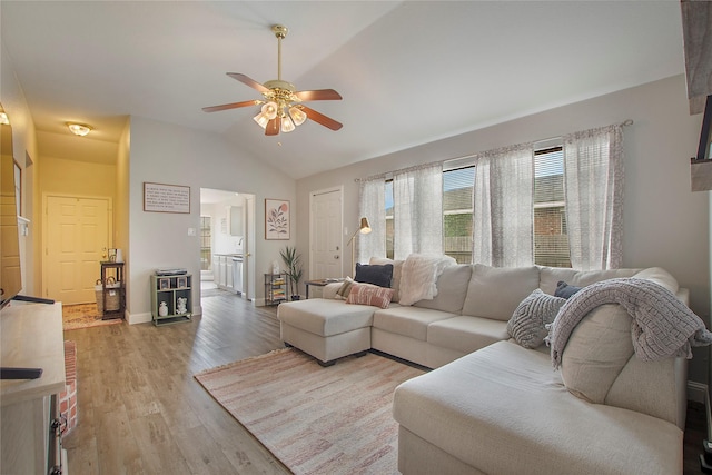 1034 Palomino Dr, Little Elm, TX 75068 - living room featuring lofted ceiling, ceiling fan, wood finished floors, and baseboards