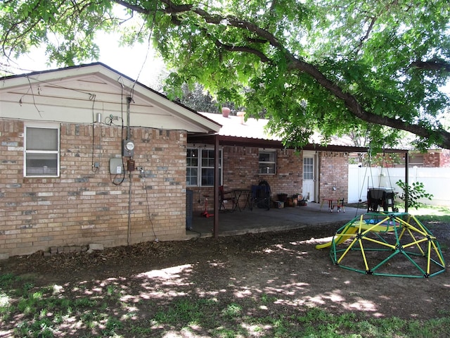 2406 14th Th, Brownwood, TX 76801 - rear view of house with a patio and brick siding