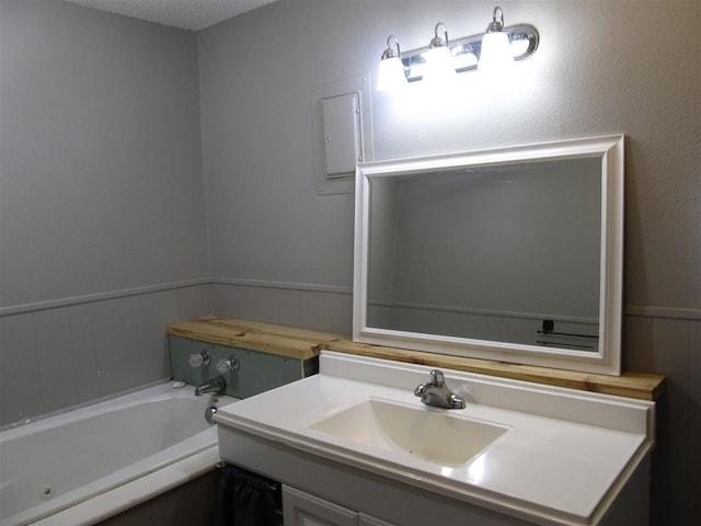 2406 14th Th, Brownwood, TX 76801 - full bathroom with a bath, a wainscoted wall, and vanity