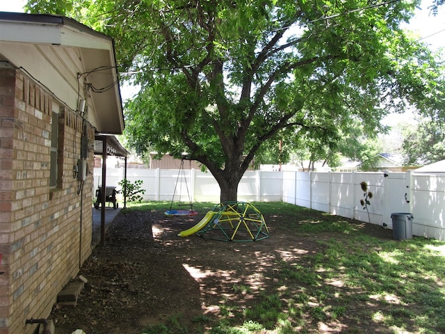 2406 14th Th, Brownwood, TX 76801 - fenced backyard with a playground