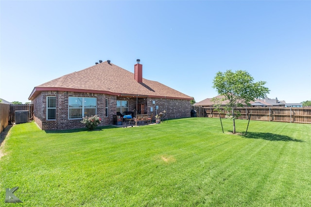 7201 Mcleod Dr, Abilene, TX 79602 - rear view of property with central AC, brick siding, a chimney, and roof with shingles