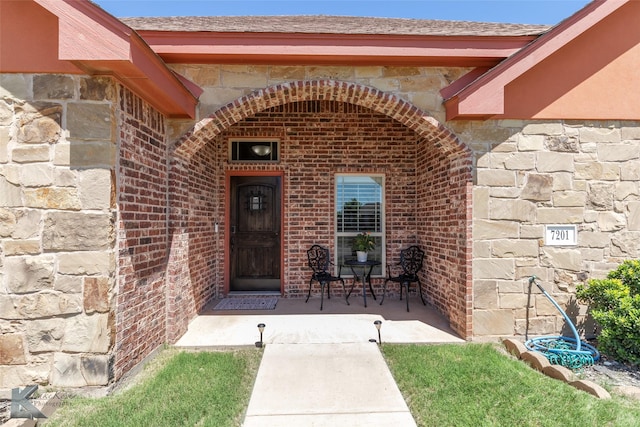 7201 Mcleod Dr, Abilene, TX 79602 - entrance to property featuring stone siding, brick siding, and a shingled roof