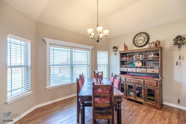 7201 Mcleod Dr, Abilene, TX 79602 - dining space featuring a chandelier, hardwood / wood-style flooring, vaulted ceiling, and baseboards