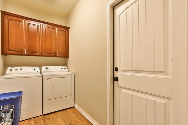 7201 Mcleod Dr, Abilene, TX 79602 - laundry room with washing machine and clothes dryer, light wood-style floors, cabinet space, and baseboards