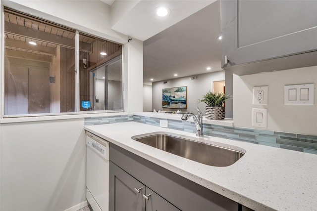 5130 Amesbury Dr Unit 103, Dallas, TX 75206 - kitchen featuring a sink, dishwasher, gray cabinetry, light stone countertops, and decorative backsplash
