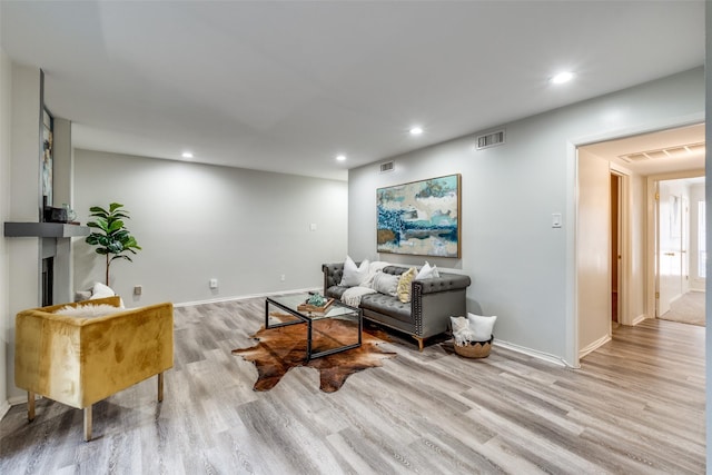 5130 Amesbury Dr Unit 103, Dallas, TX 75206 - living room featuring light wood finished floors, baseboards, recessed lighting, and a fireplace