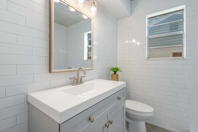 6012 Whispering Ln, Watauga, TX 76148 - half bath featuring tile walls, toilet, and vanity