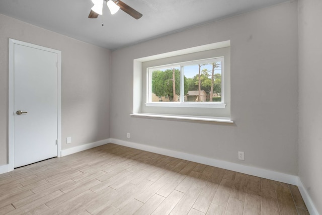 6012 Whispering Ln, Watauga, TX 76148 - empty room with ceiling fan, light wood-style floors, and baseboards