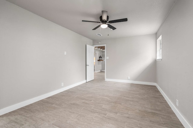 6012 Whispering Ln, Watauga, TX 76148 - spare room featuring a ceiling fan, baseboards, and light wood-type flooring